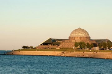 The dome shaped planetarium sits at the edge of Lake Michigan.