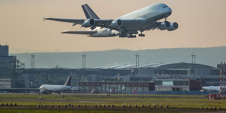 A plane takes off of the runway outside the Frankfurt Airport.