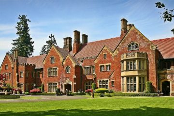 Brick castle with courtyard out front and green lawn.