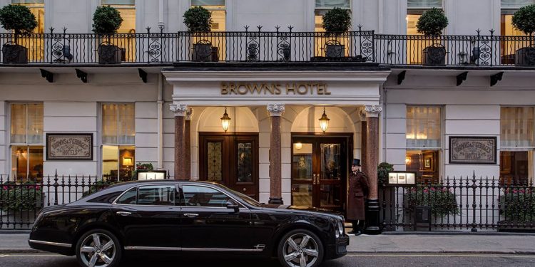 A doorman stands at the front entrance to Brown's Hotel in London.