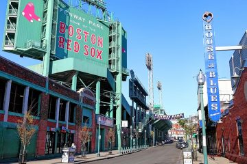 The 'Home of the Boston Red Sox' sign above an entry to Fenway Park.