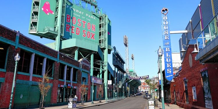 The 'Home of the Boston Red Sox' sign above an entry to Fenway Park.