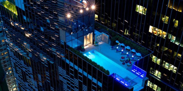 A rooftop pool at the Hotel Indigo, complete with lounge chairs.