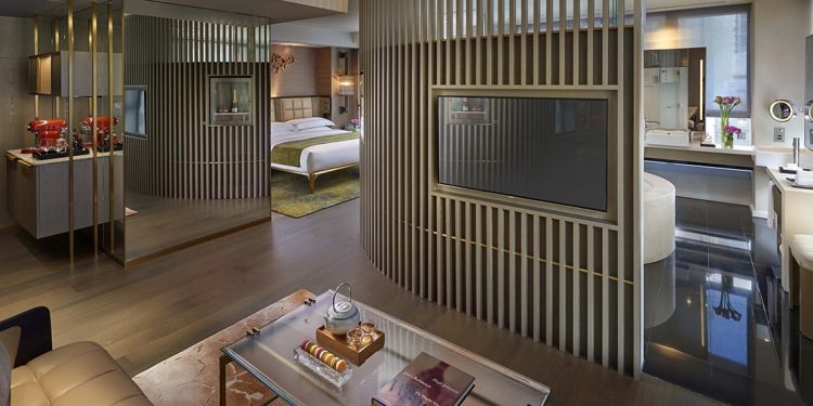 A modern looking room at the Landmark Mandarin with view of the bathroom, bedroom and sitting room.