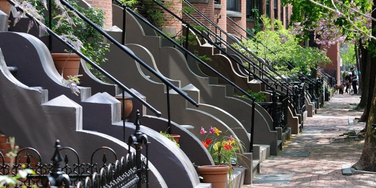 A row of front steps on a cobblestone street in Boston's South End.