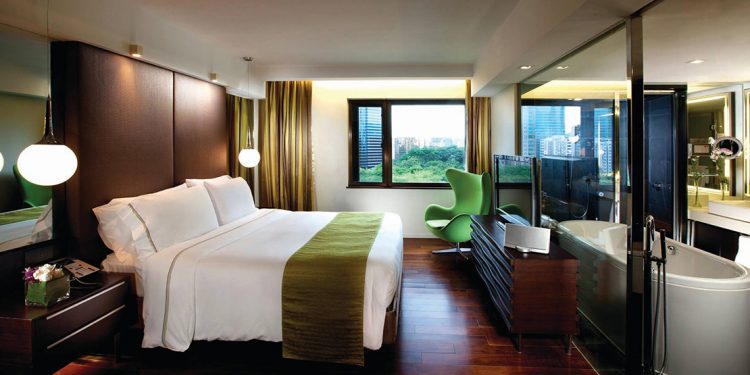 An upscale hotel room in the Mira hotel featuring the bedroom and bathroom.