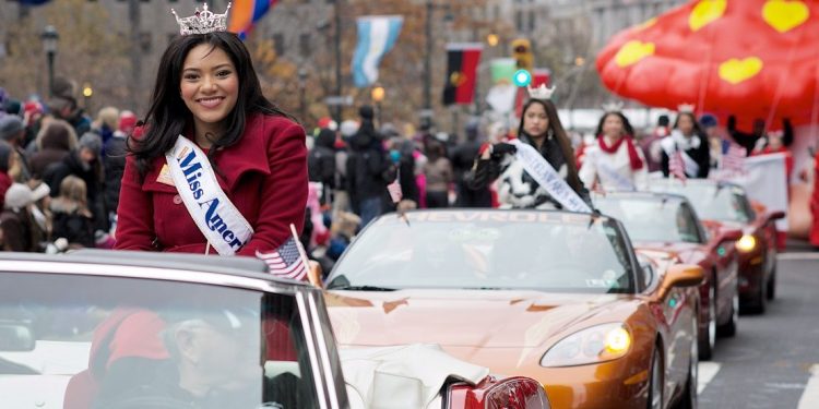 Miss America Outstanding Teen 2015, Olivia McMillan, waves to the crowds at Love Park as she sits in the back of a convertible that takes part in the annual Thanksgiving Day Parade in Philadelphia.