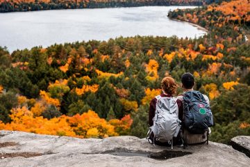 A couple admire a view while hiking in Canada