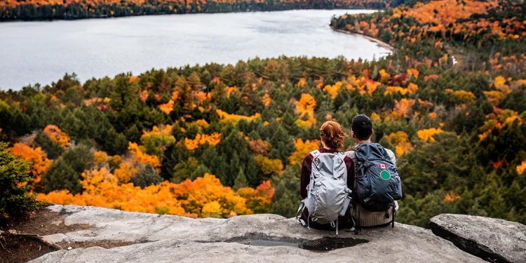 A couple admire a view while hiking in Canada