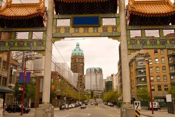 Square arches with cement pillars over top of street.