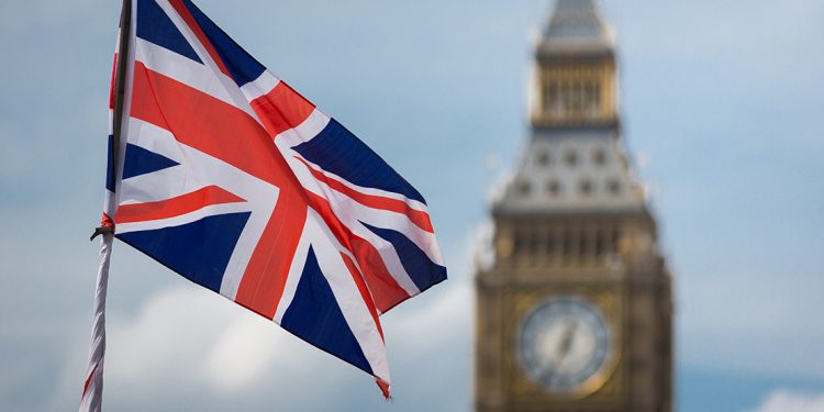 Union jack in front of clock on Big Ben