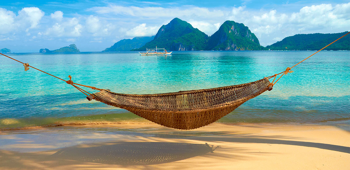 A hammock on a beach in the Philippines