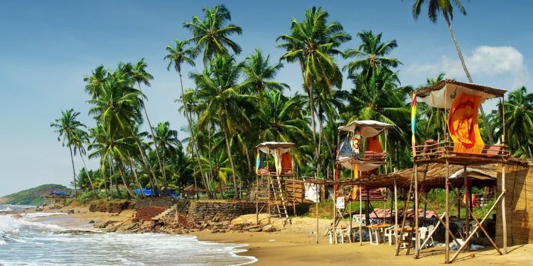 A sunny, shack-dotted beach in Goa, India