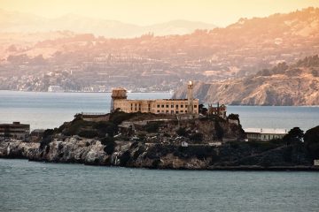 Alcatraz on an island with city in the background.