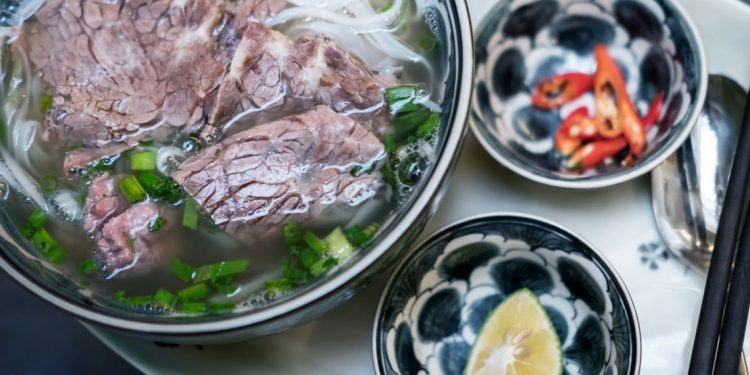 Beef pho in a bowl.