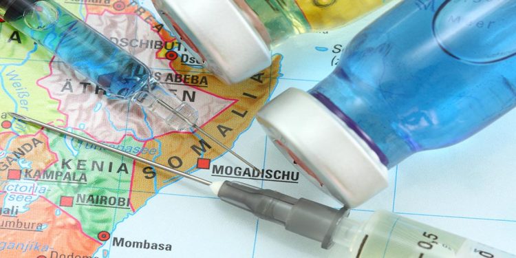 travel vaccination needles on a map