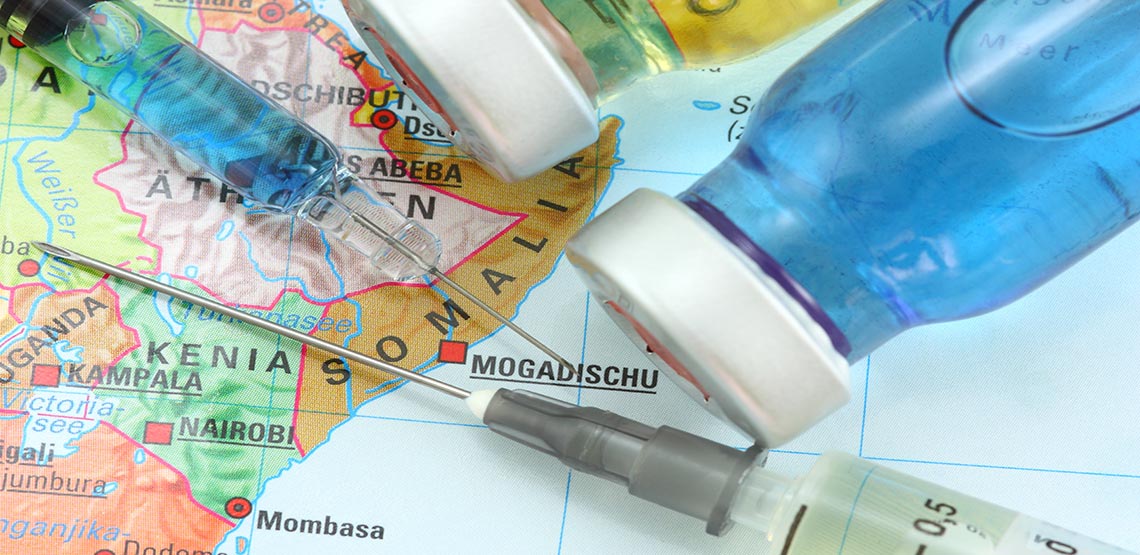 travel vaccination needles on a map