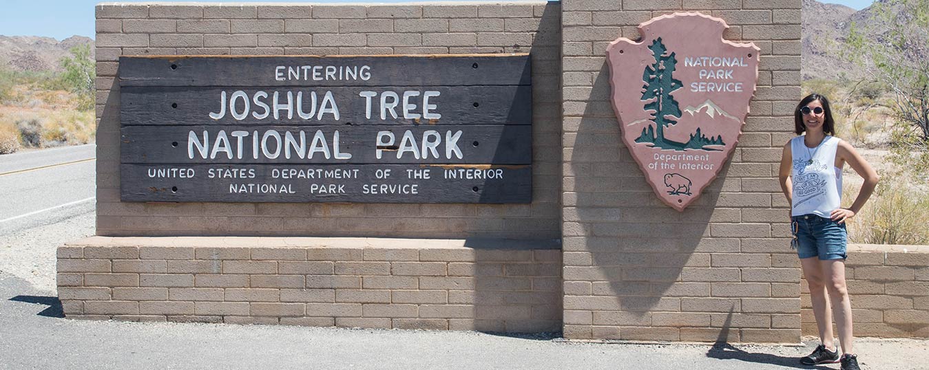 Liana standing in front of Joshua Tree National Park sign