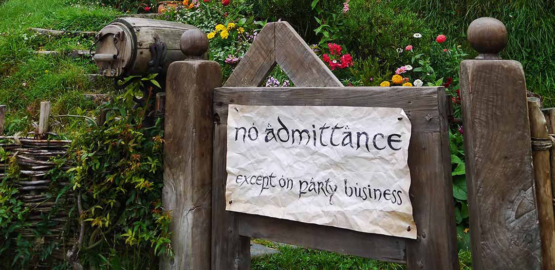Sign on gate reading "no admittance except on party business"