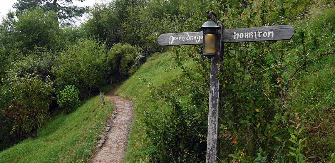 Path and signpost reading "green dragon" and "hobbiton"