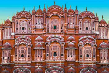 A frontal view of the The Palace of the Winds (also known as the Hawa Mahal) and its delicately carved rose-colored windows