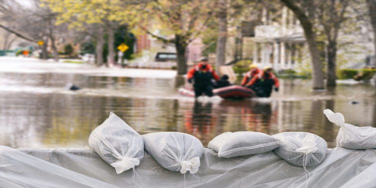 sandbags hold back a flood on a street during a hurricane