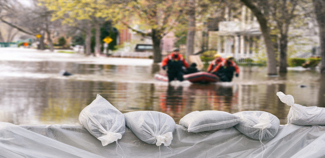 sandbags hold back a flood on a street during a hurricane