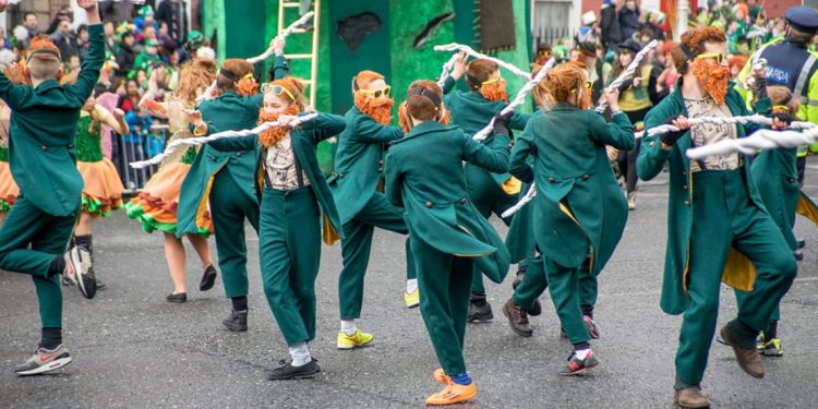 People dressed in green and with beards dancing in streets of Dublin.