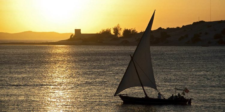 dhow sailboat at sunset off the coast of Lamu, Kenya