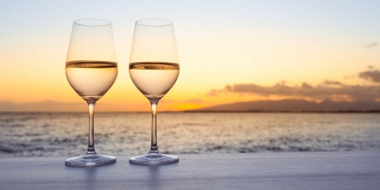 A pair of wine glasses on the beach