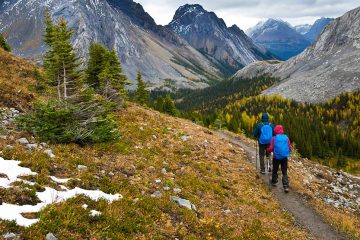Two people hiking on trail in mountains