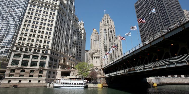 Views of Chicago's Wrigley building and tribune towers from a Michigan Avenue river walk.
