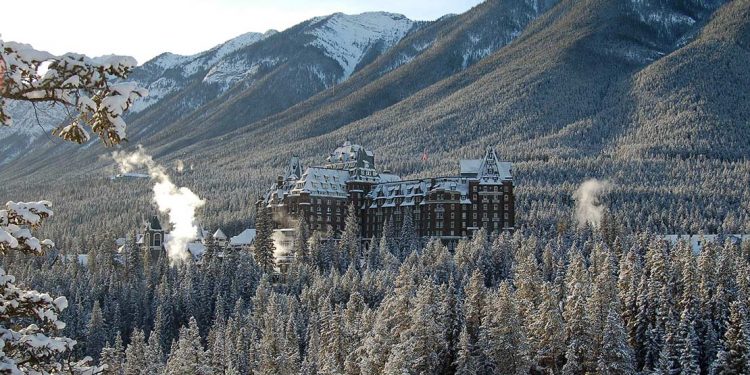 Banff Springs Hotel among snow covered trees in the wintertime