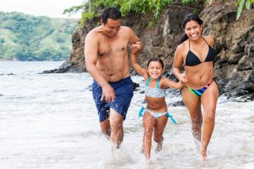 Family running on the beach in Costa Rica