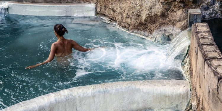Woman enjoying the Pah Tempe hot springs by the Virgin River, Utah