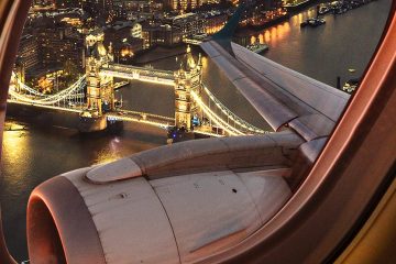 View out a plane window of London Bridge lit up at night