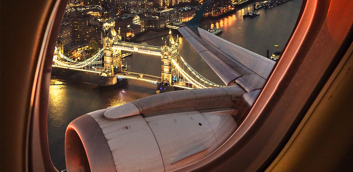 View out a plane window of London Bridge lit up at night