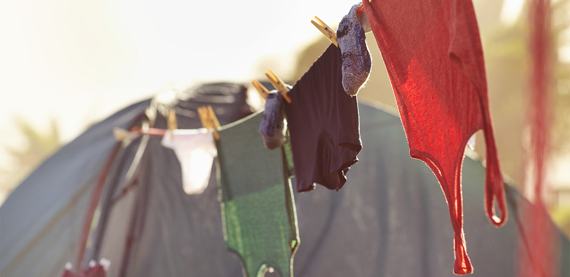 Clothes hanging on clothes line attached to tent