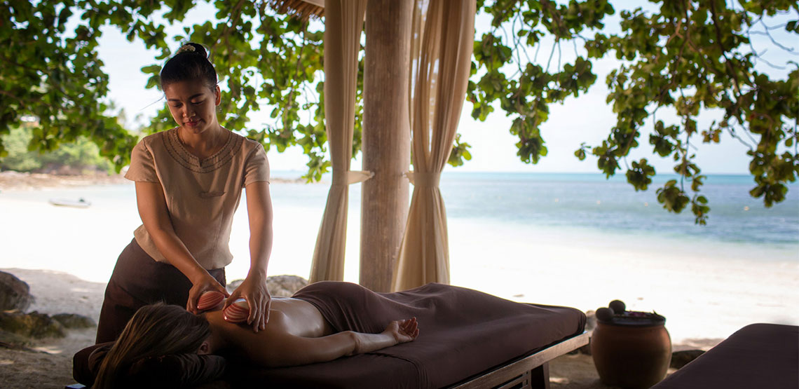 Someone receiving a massage on the beach