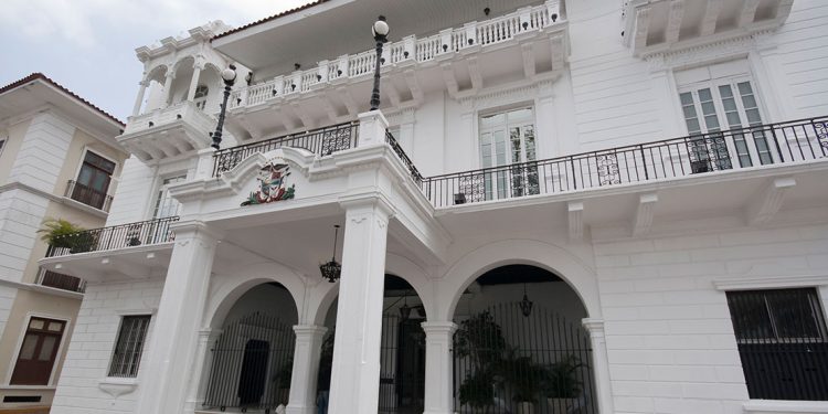 White building with many verandas and arched doorways