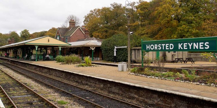 Railway tracks in front of "Horsted Keynes" sign