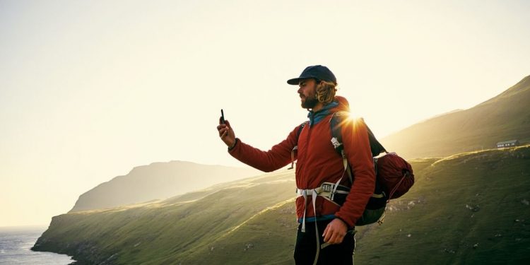 Man using smart phone while hiking