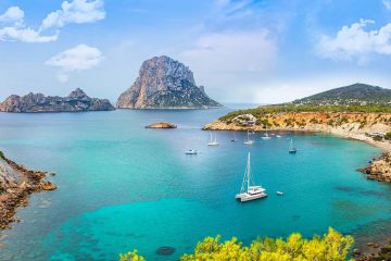 Ibiza landscape with teal waters and boats.