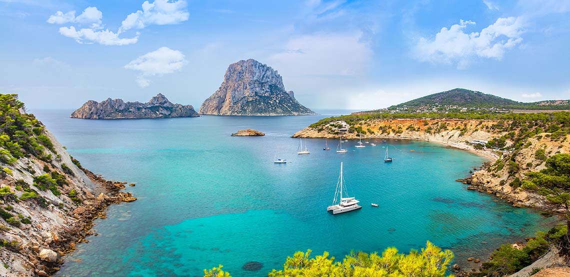 Ibiza landscape with teal waters and boats.