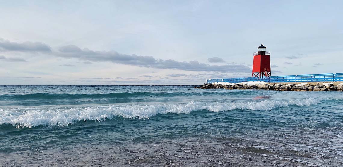 A beach and a red lighthouse.