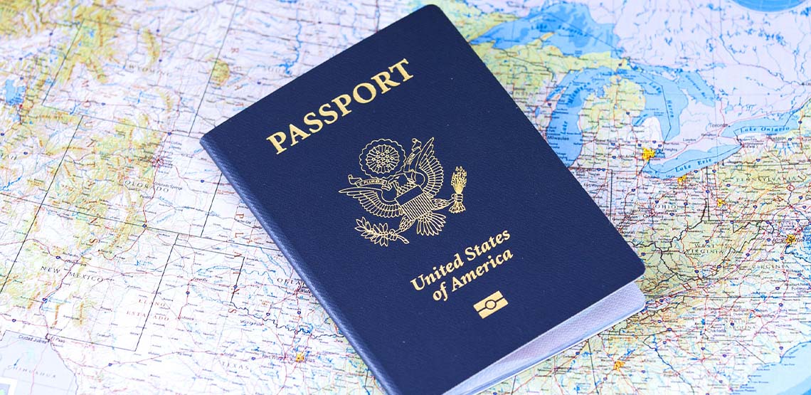 A blue passport laying on a map.