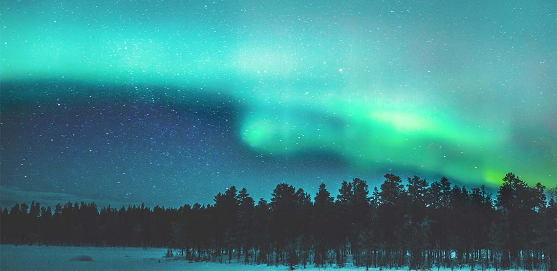 Landscape of green and blue Northern Lights.