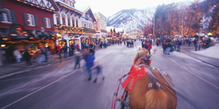 An in-motion snap shot of Leavenworth, Washington while someone is riding in a chariot.