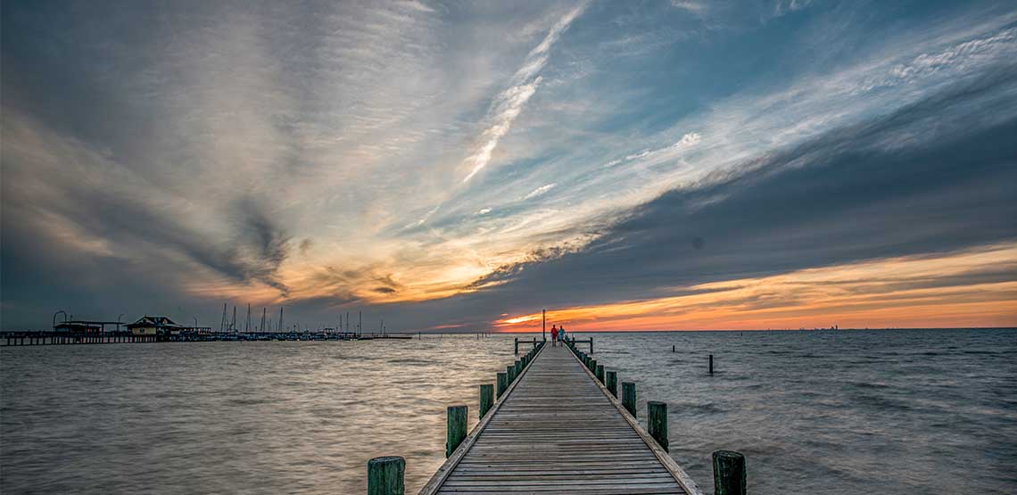 A doc in Fairhope, Alabama at sunset.