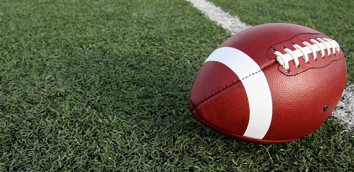 A football resting on grass.